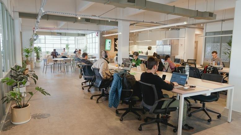 Spacious open-plan workspace at HUERTA, 1967 Humboldt, featuring natural light, plants, and collaborative desks.