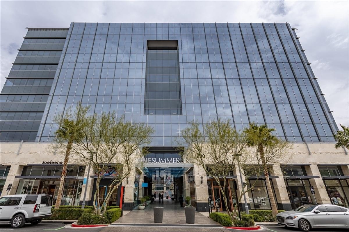 Exterior view of the glass-facade building at 1980 Festival Plaza Drive, Suite 300.
