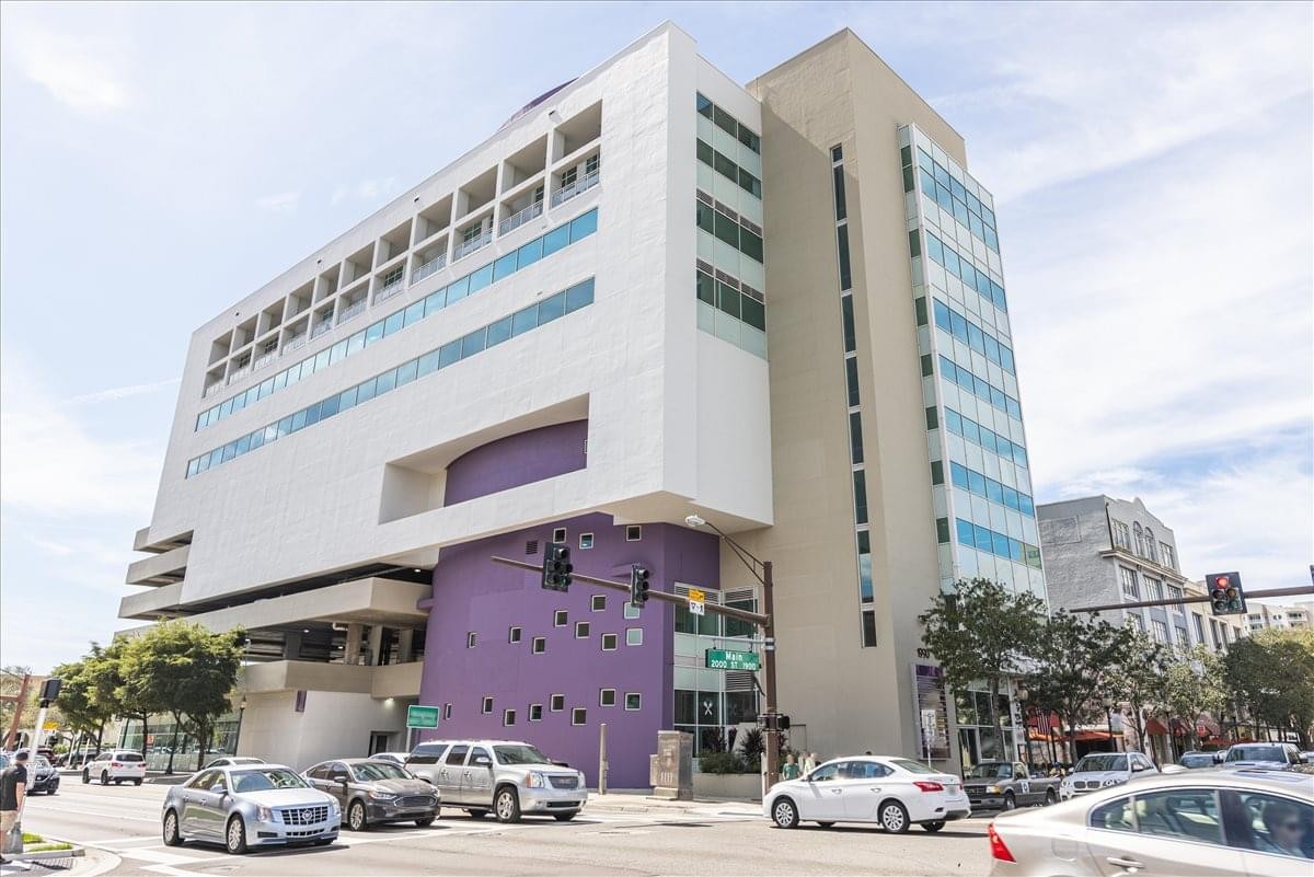 Modern multi-story exterior of the 1990 Main Street building with purple architectural accents.