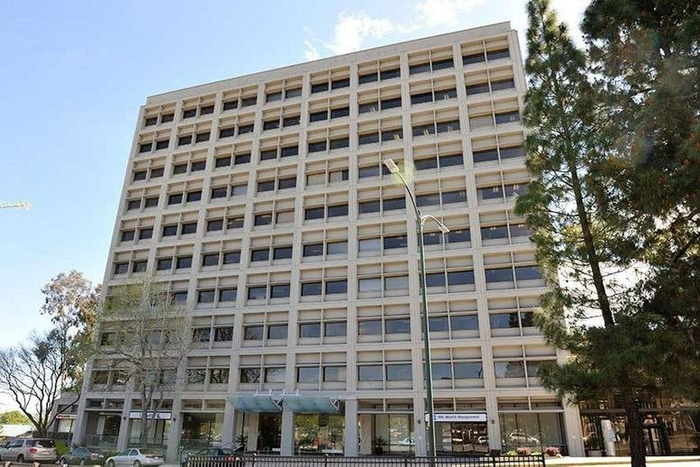 Exterior view of the white facade and window grid at 1 Ygnacio Center.