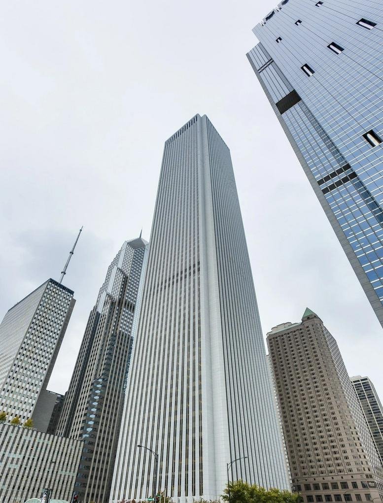 Exterior upward view of the towering white AON Center at 200 East Randolph Street.
