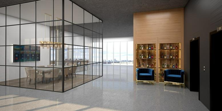 Spacious reception area at 200 Kent Avenue Offices featuring a glass-walled meeting room and velvet armchairs.