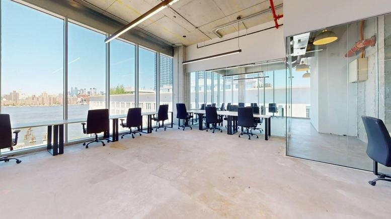 Open-plan office with glass walls and river views.