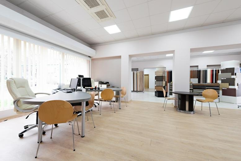 Bright, modern open-plan workspace at 200 Portland Street with light wood floors and several workstations.