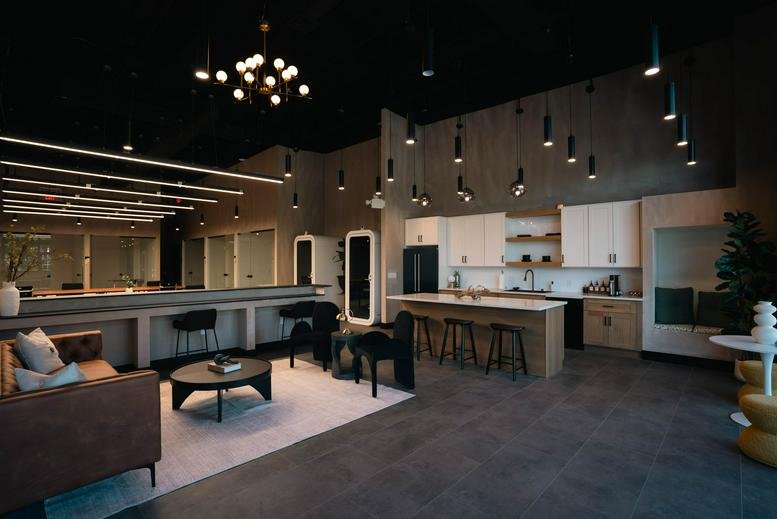 Spacious communal lounge and kitchen area at Work'd Up, 200 Old Tappan Road with modern pendant lighting.