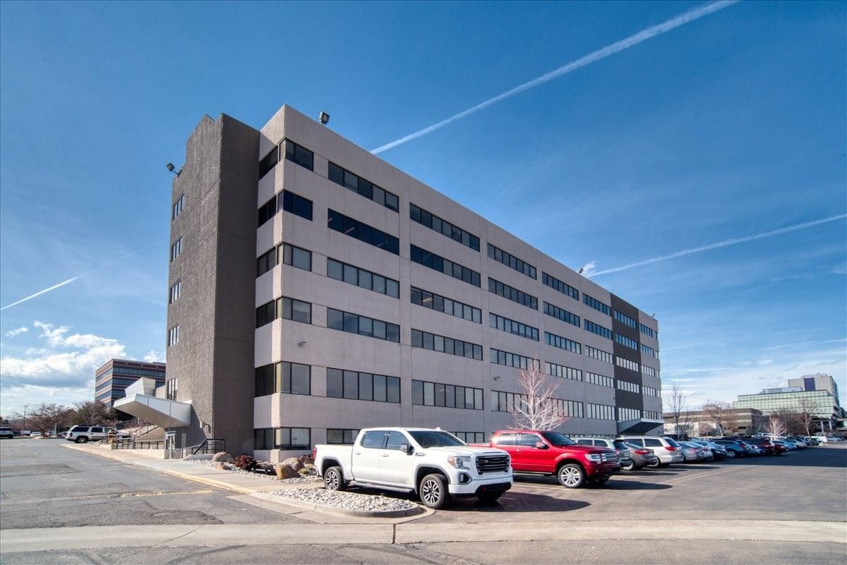 Exterior view of the multi-story office building at 200 Union Blvd. under a bright blue sky.