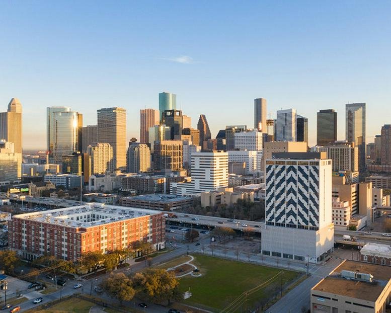 Distant skyline view of 2000 Crawford Street and downtown Houston at sunset.