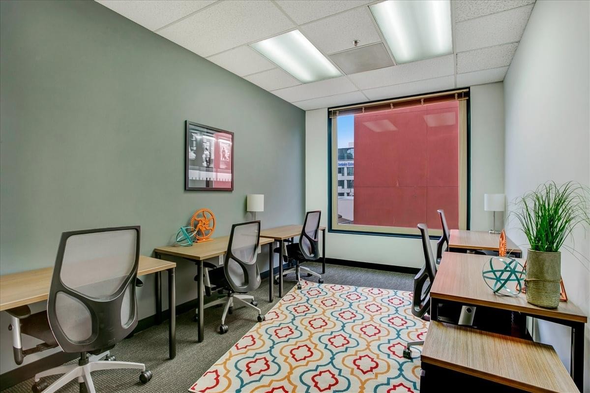 Professional workspace at 2001 Addison Street featuring multiple desks and a large colorful patterned rug.