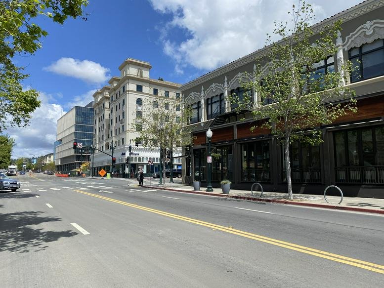Exterior view of the historic 2006 Kala Bagai Way building on a sunny street corner.