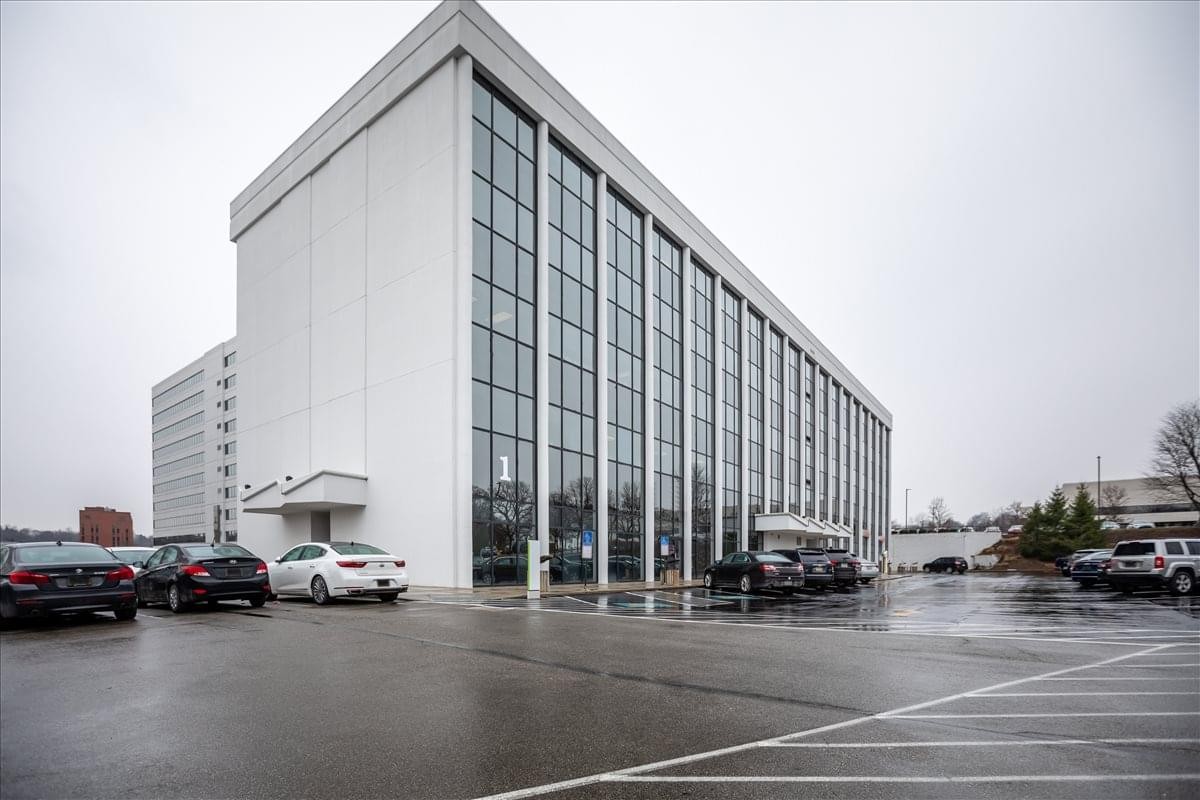 Exterior view of the glass-facade building at 201 Penn Center Boulevard.