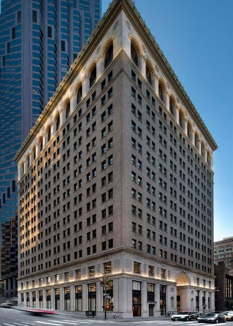 Grand exterior facade of 201 Spear Street featuring a triangular architectural design with arched upper windows.