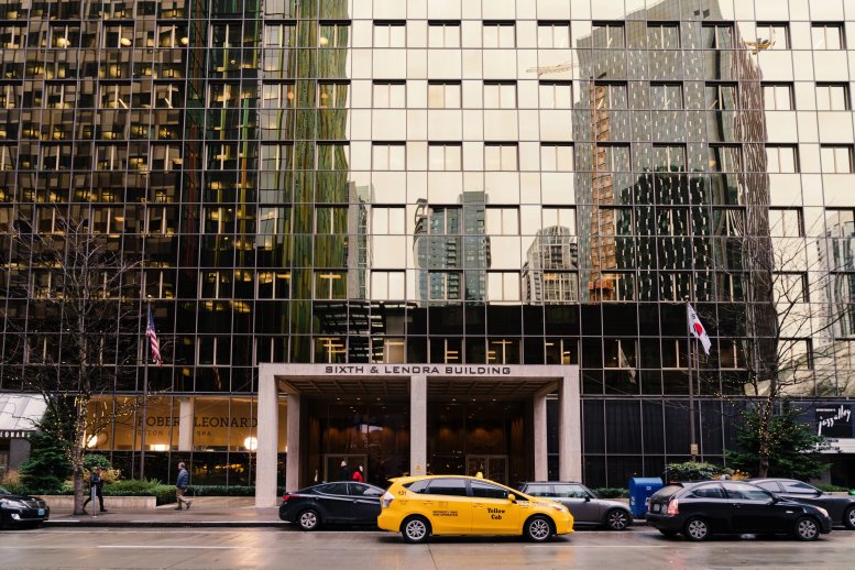 Exterior view of the glass-facade Sixth & Lenora Building with street-level retail.
