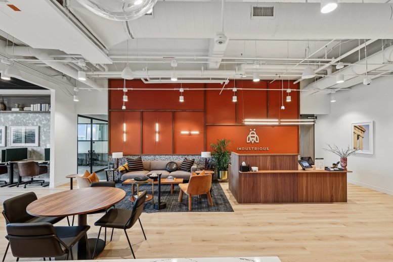 Spacious reception area at Nashville Yards with wood paneling and warm designer seating.
