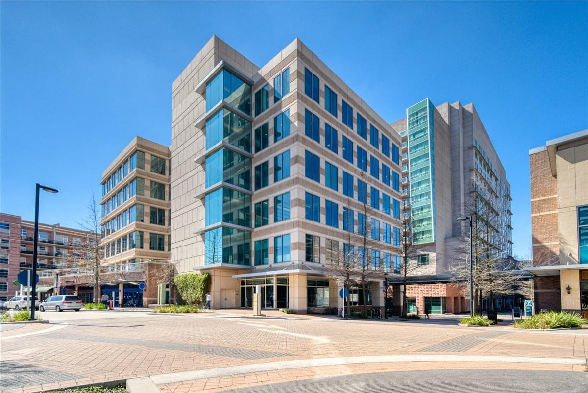 Modern glass-facade exterior of the office building at 21 Waterway Avenue.