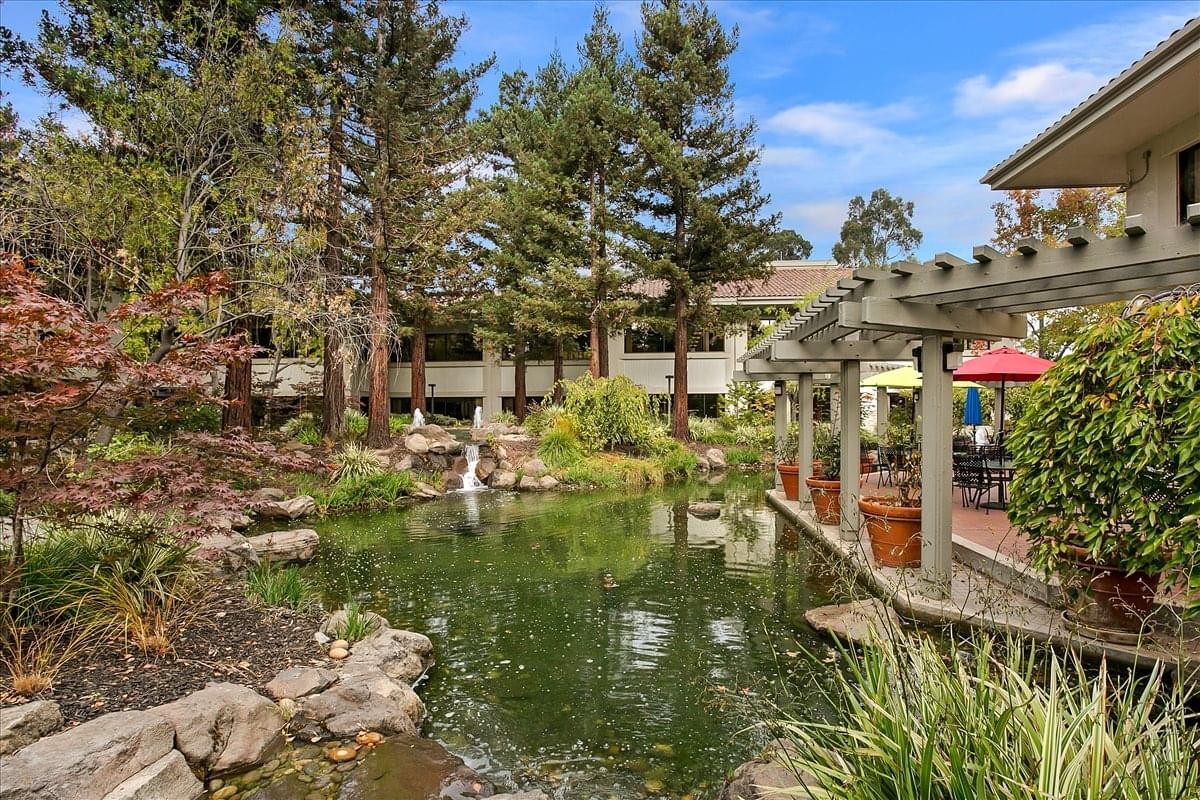 Exterior view of the landscaped pond and garden courtyard at 2100 Geng Road, Embarcadero Place.