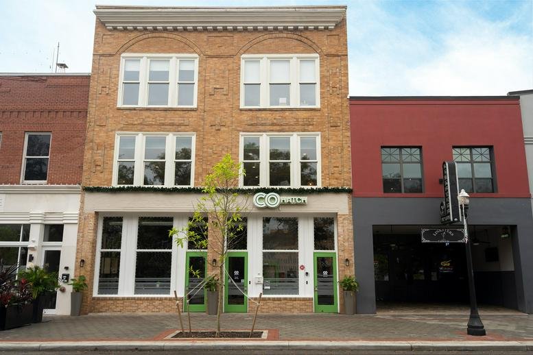 Three-story brick exterior building of COhatch Lakeland at 211 East Main Street.