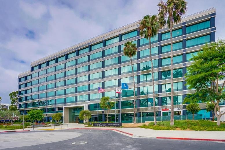 Exterior view of the glass-facade Computax Building at 21250 Hawthorne Blvd.