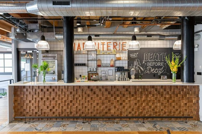 Spacious communal bar area at 220 N Green St with wood-textured front and industrial ceiling.