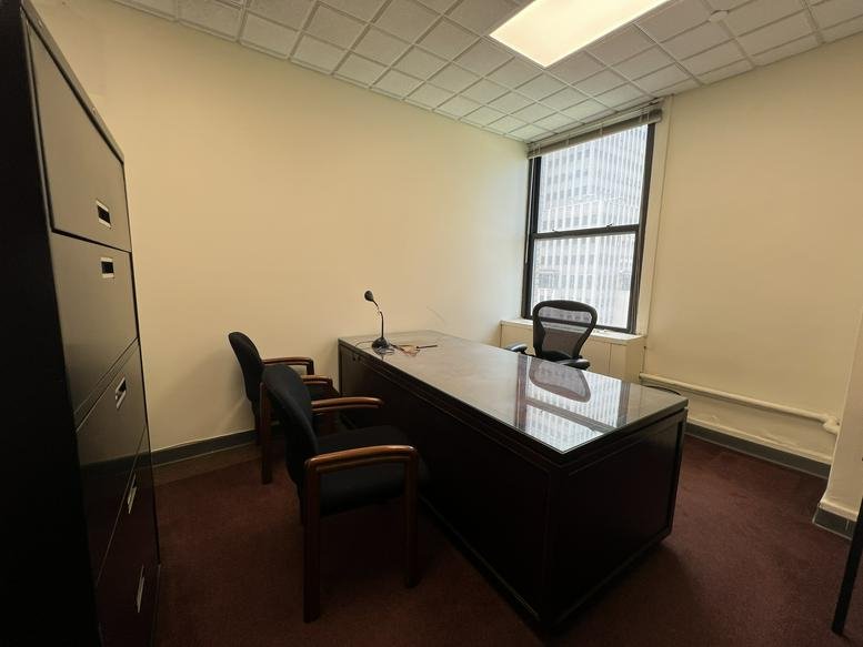 Spacious private office at 225 Broadway, Suite 1606 with a large dark wood desk and city views.