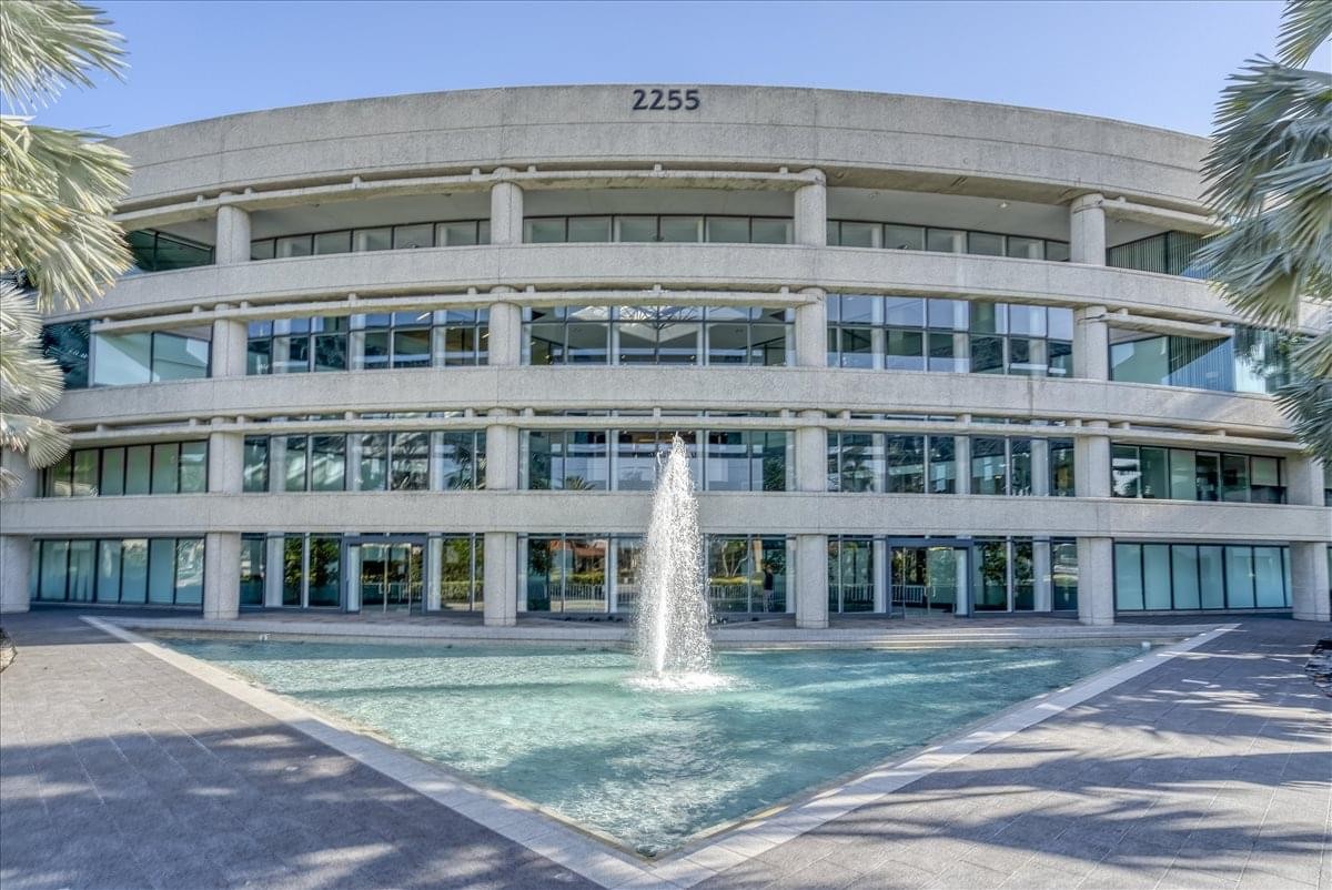 Exterior view of the curved concrete and glass facade of Glades Road Center.