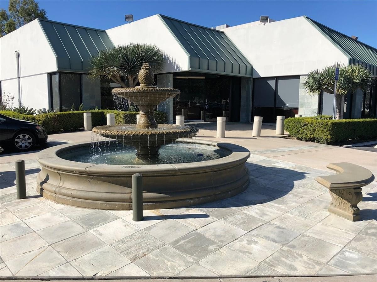 Exterior view of the white building and tiered water fountain at 2372 Morse Avenue.
