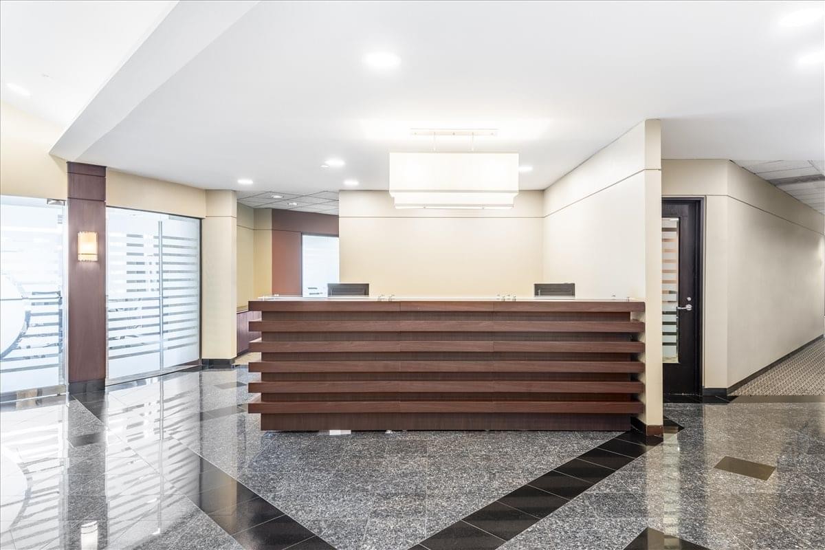 Professional lobby of the First Street Center, 18th Floor, featuring a slatted wood reception desk.