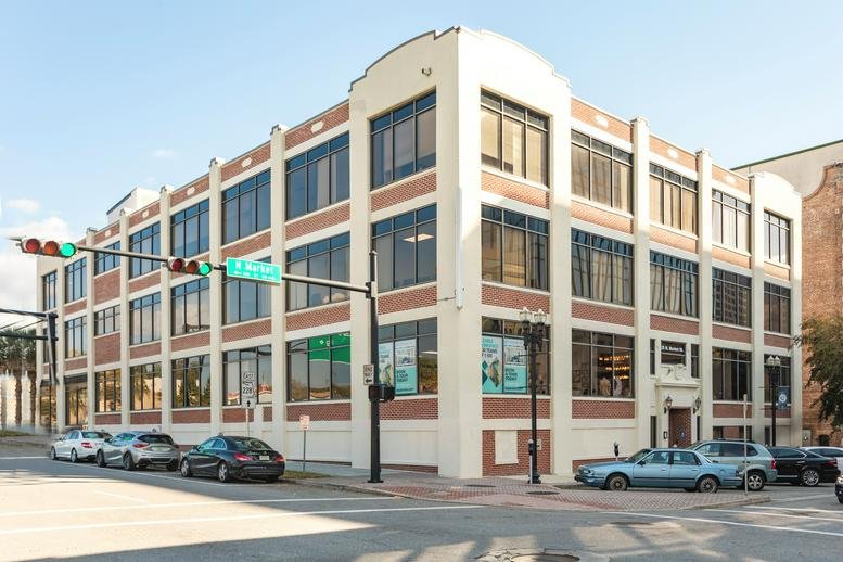 Exterior view of the white brick building at 25 N. Market St. with large windows.