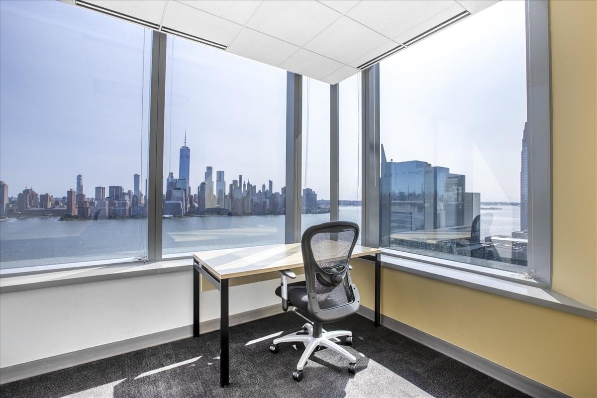 Private office at 2500 Plaza 5, Harborside Financial Center with a panoramic view of the Manhattan skyline.