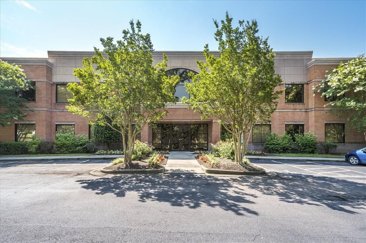 Exterior view of the brick facade and landscaped entrance at 2500 Regency Parkway.