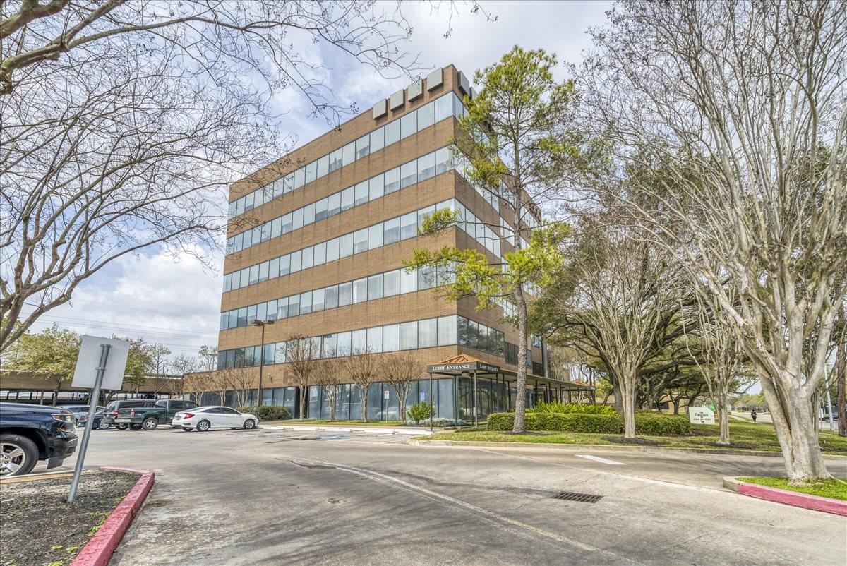Exterior view of the multi-story brick facade at The Wilcrest Business Center.