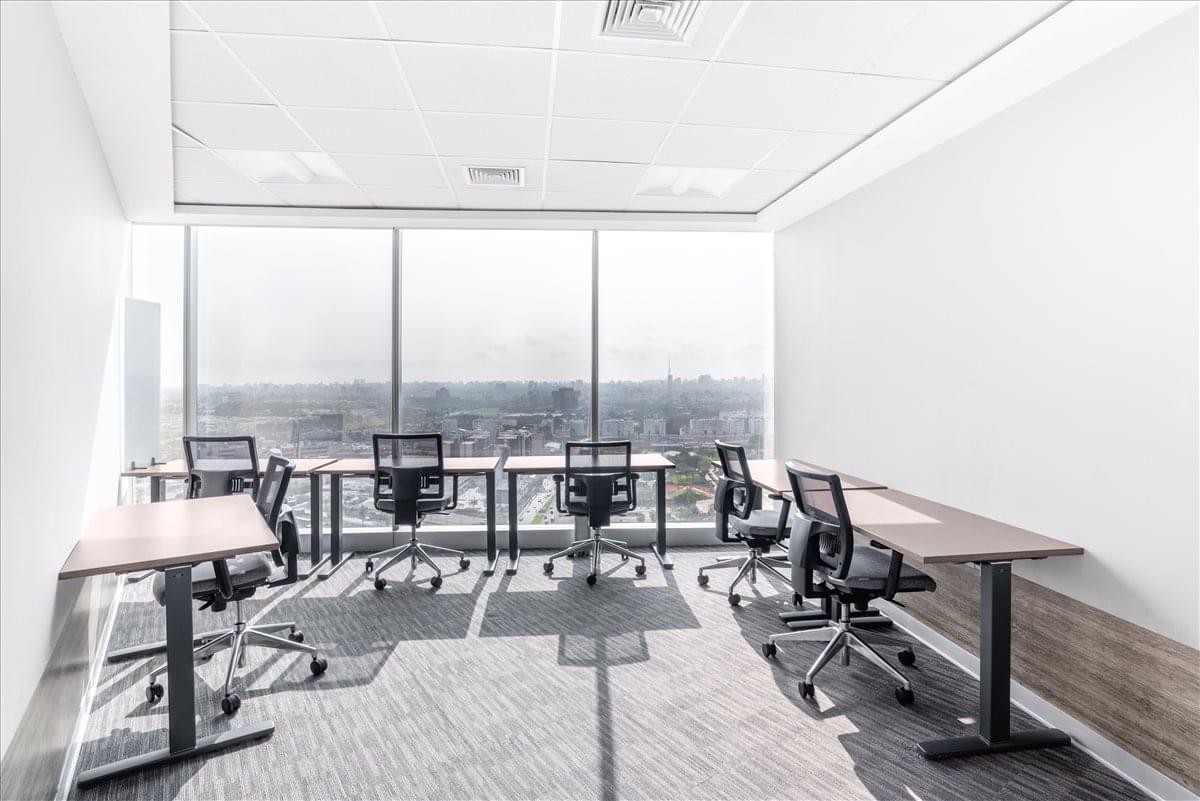 Spacious corner office at 254 El Derby Avenue, Suite 2501 with multiple desks and panoramic city views.