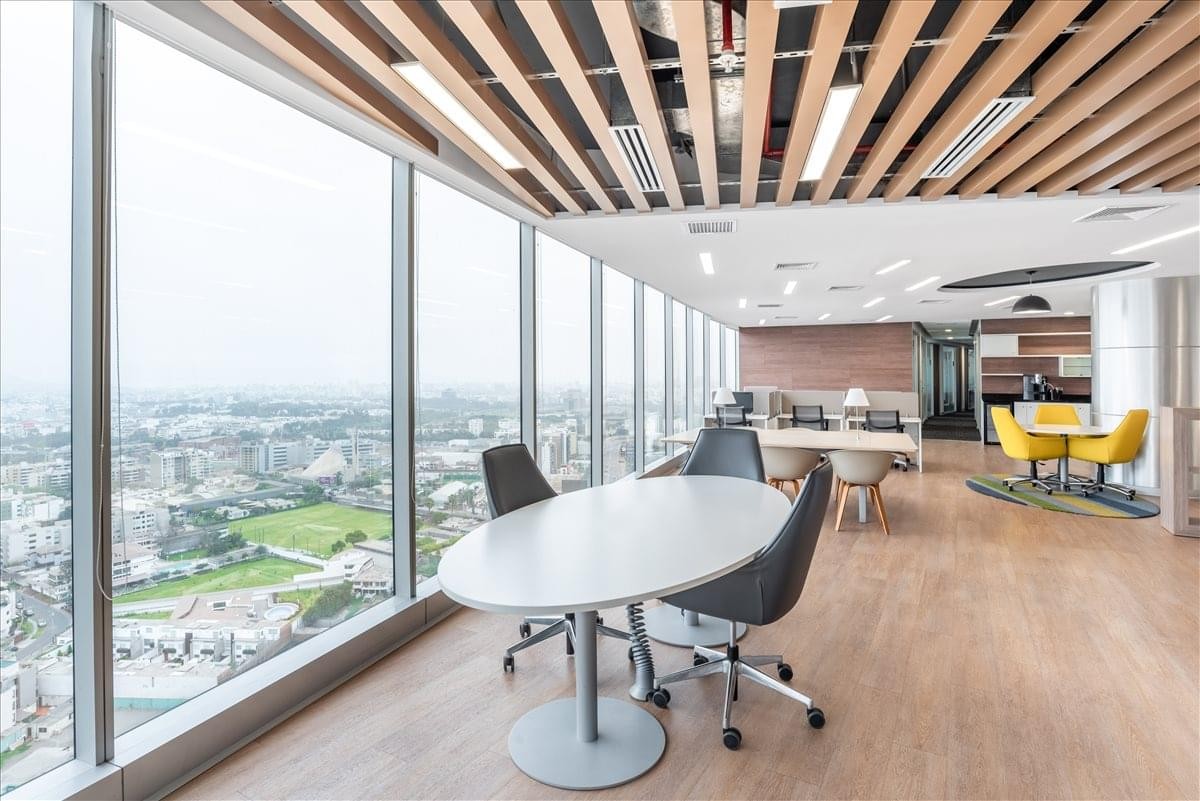 Spacious communal lounge at 254 El Derby Avenue, Suite 2501, featuring a wood-slat ceiling and city views.