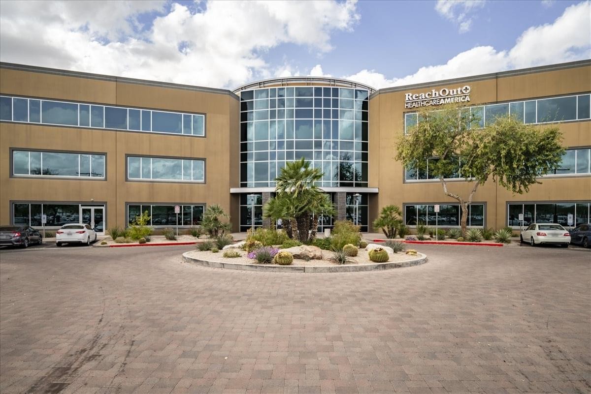 Exterior view of the Union Hills Office Plaza building with glass entrance and brick facade.