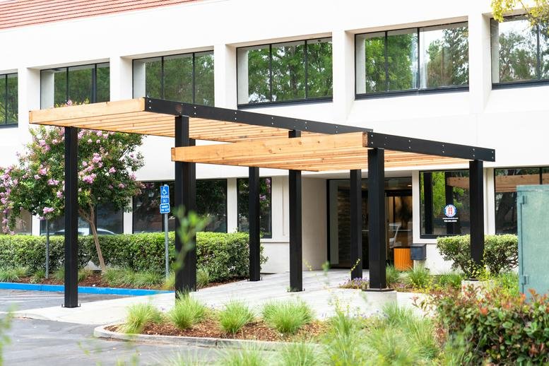 Exterior entrance of 2551 San Ramon Valley Boulevard featuring a modern wood and steel pergola.