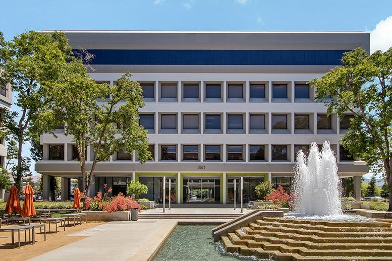 Exterior view of the multi-story office building at 2570 N. First Street, 2nd Floor with a tiered fountain.