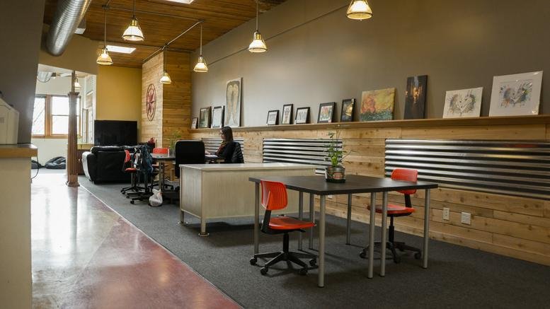Spacious open-plan coworking area at Spark Commons, 258 4th Street with diverse seating and natural light.