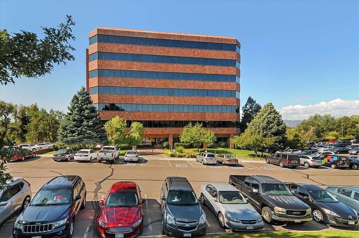 Exterior view of the brick-and-glass Kellogg Building in a landscaped office park.