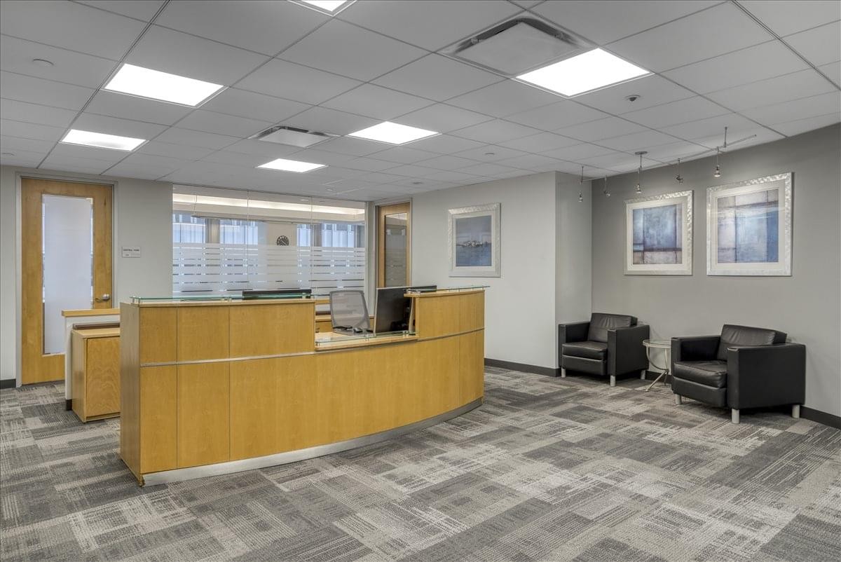Spacious reception area at 260 Madison Avenue featuring a curved wooden desk and modern seating.