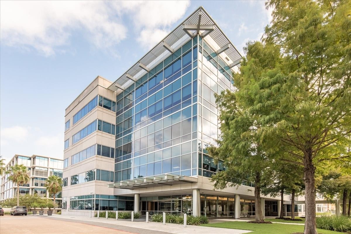 Exterior view of the glass and stone South Shore Harbour Center building facade.