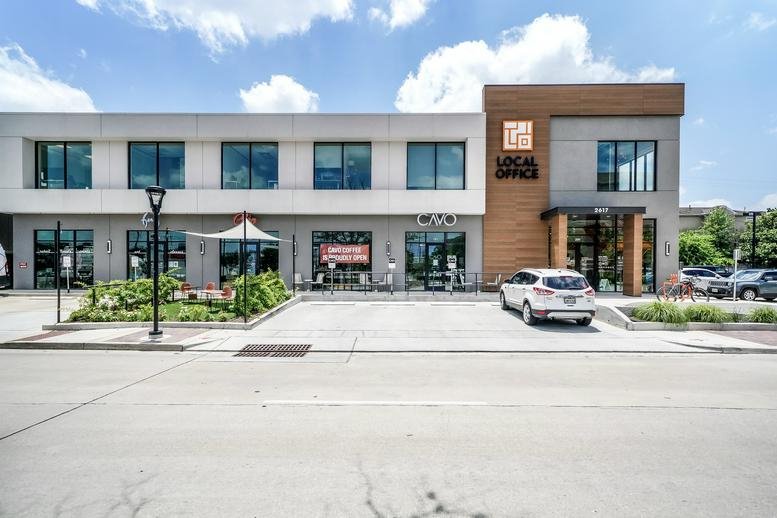 Exterior view of the modern two-story brick and white facade building at 2617 Bissonnet Street.