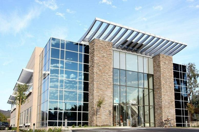 Exterior view of the stone and glass building at 2629 Townsgate Road, Suite 235.