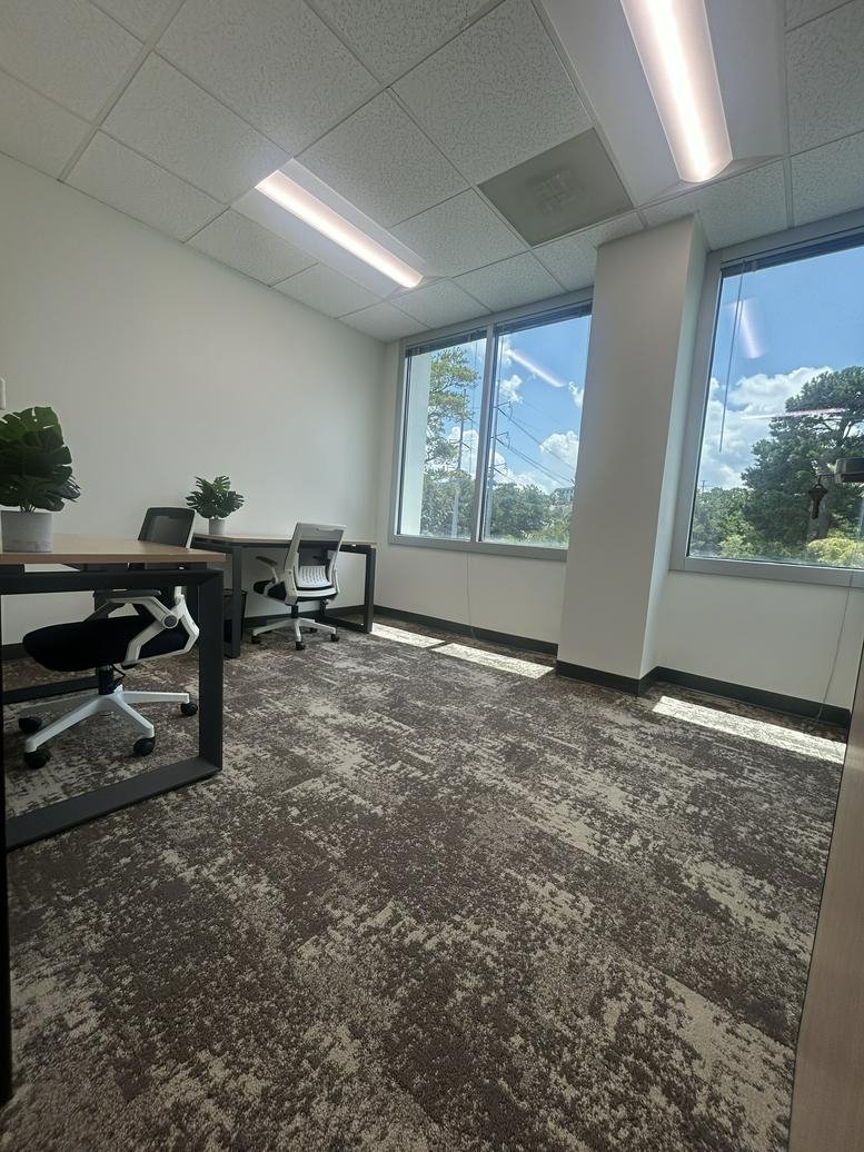 Bright two-person office suite at 2700 Cumberland Pkwy SE with large windows and natural light.