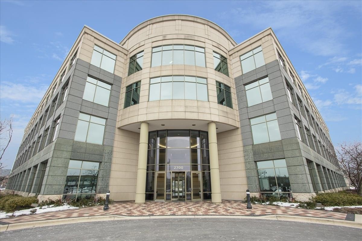 Exterior view of the grand stone facade and entrance at 2700 Patriot Boulevard.