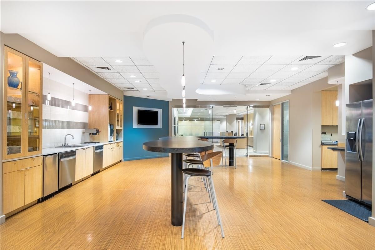 Modern communal kitchen and breakout area at Riverside Center, Suite 2-400.