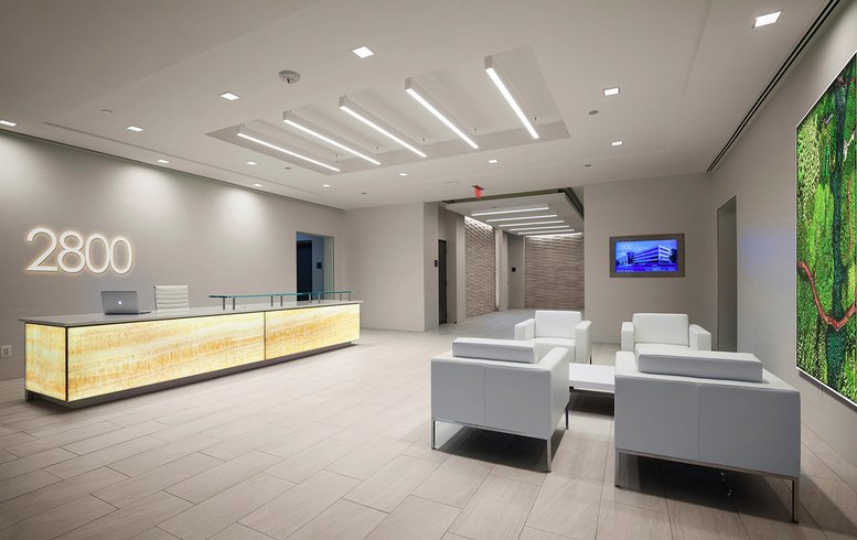Spacious modern lobby at 2800 Eisenhower Avenue, Suite 220 with an illuminated stone reception desk.