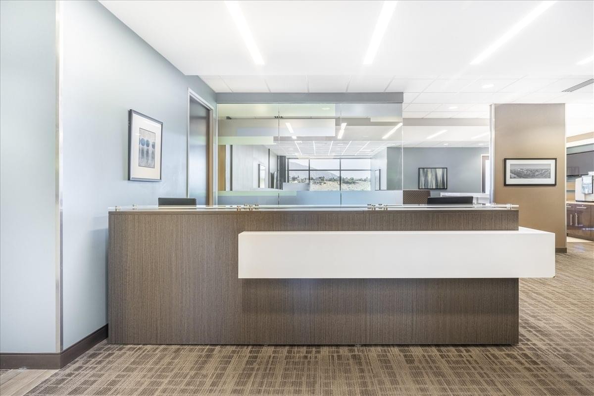 Professional reception desk at 2825 East Cottonwood Parkway, Suite 500 with modern wood paneling.