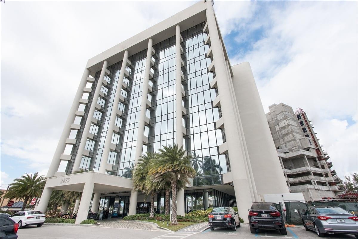 Exterior view of the multi-story glass and concrete facade at Turnberry Plaza.