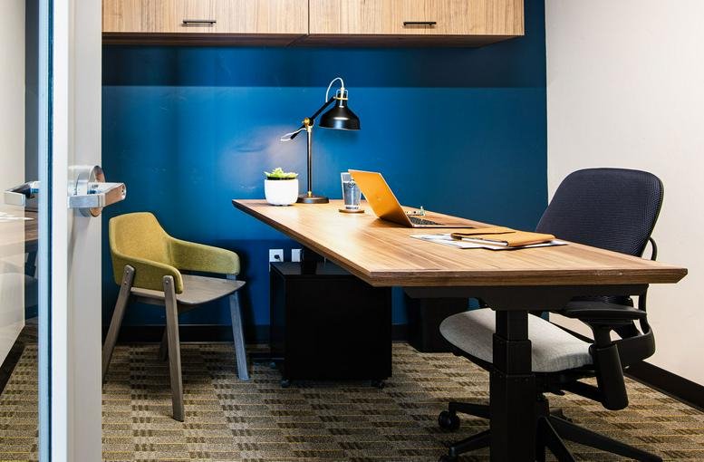 Conference room looking out onto a wooded landscape through large windows.