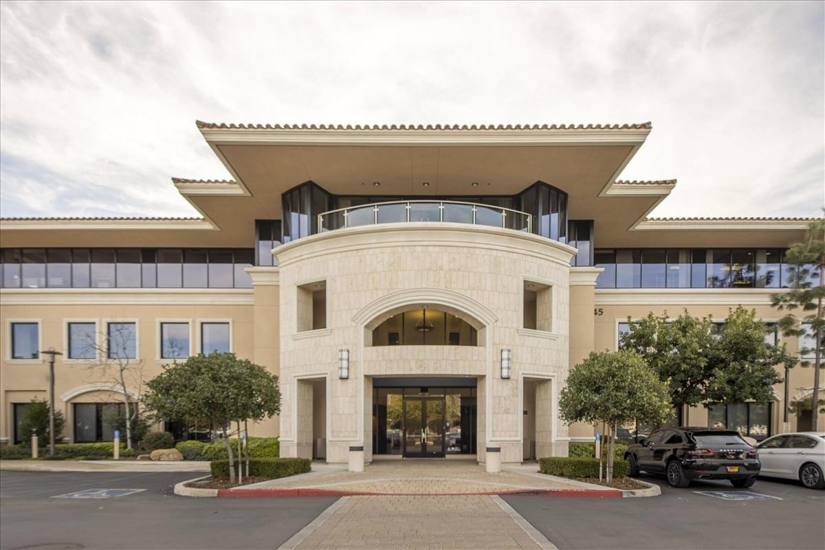 Exterior entrance of 2945 Townsgate Road, Suite 200 with symmetrical stone architecture and manicured landscaping.