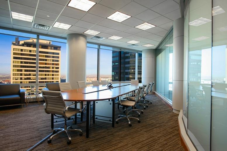 Spacious boardroom with a curved table and floor-to-ceiling city views.